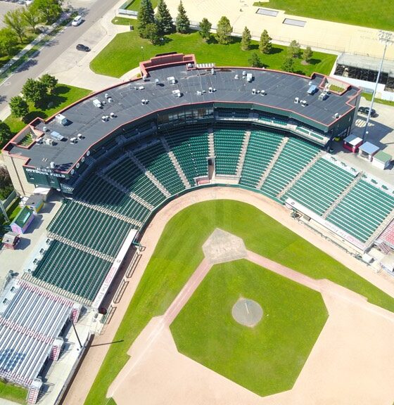 Aerial view of an empty baseball stadium surrounded by trees