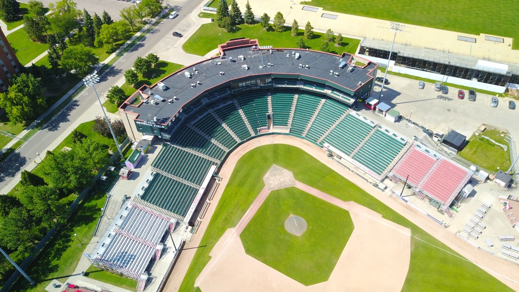 Aerial view of an empty baseball stadium surrounded by trees