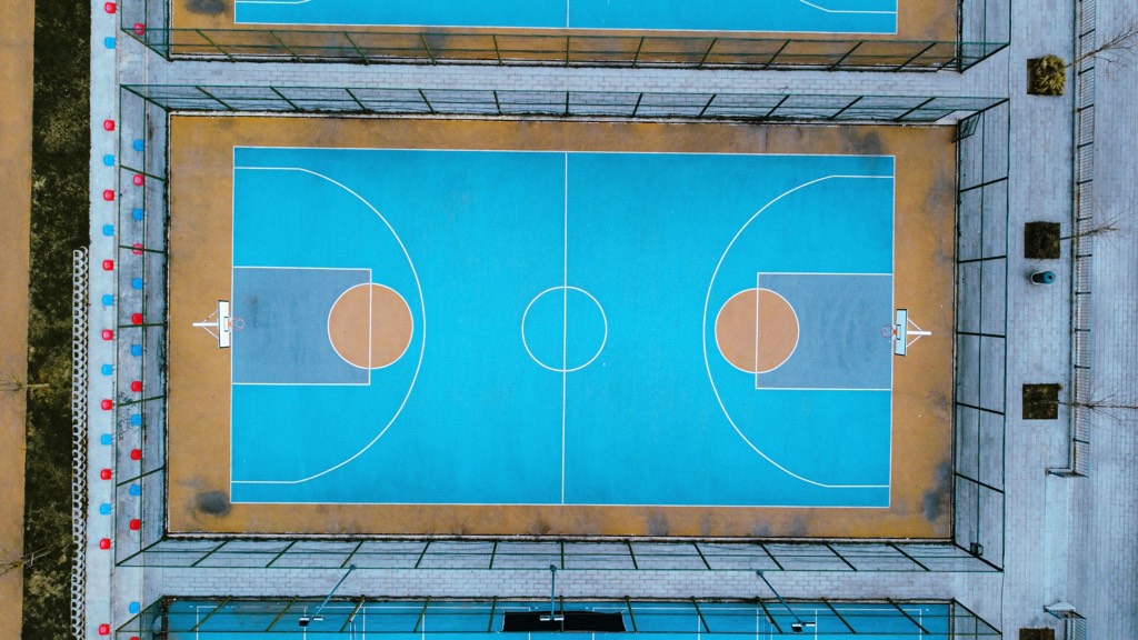 Aerial view of an empty blue outdoor basketball court
