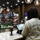 Person using a tablet at a cannabis dispensary counter
