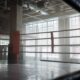 Empty boxing ring in a bright gym with tall windows