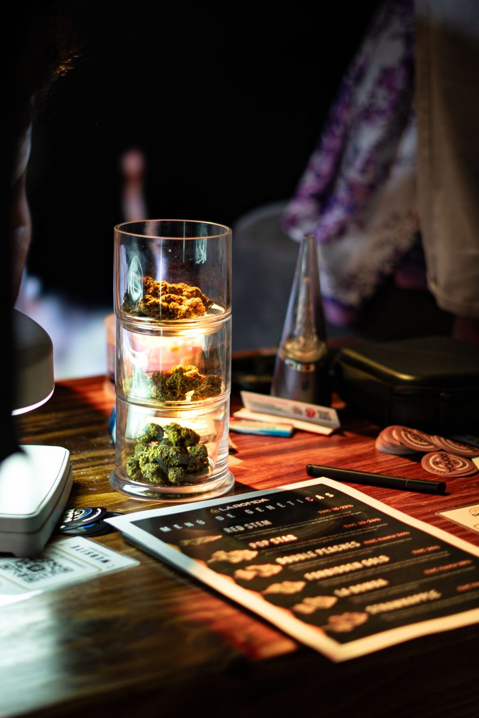 Cannabis flower in glass display jars on a dispensary counter
