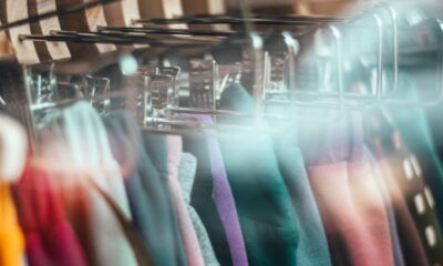 Clothing hanging on a rack behind a shop window