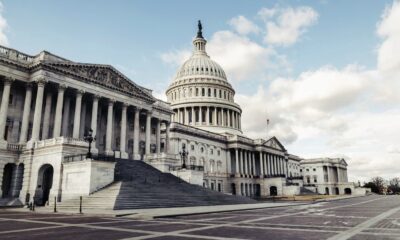 United States Capitol building with its dome and columns beneath a blue sky