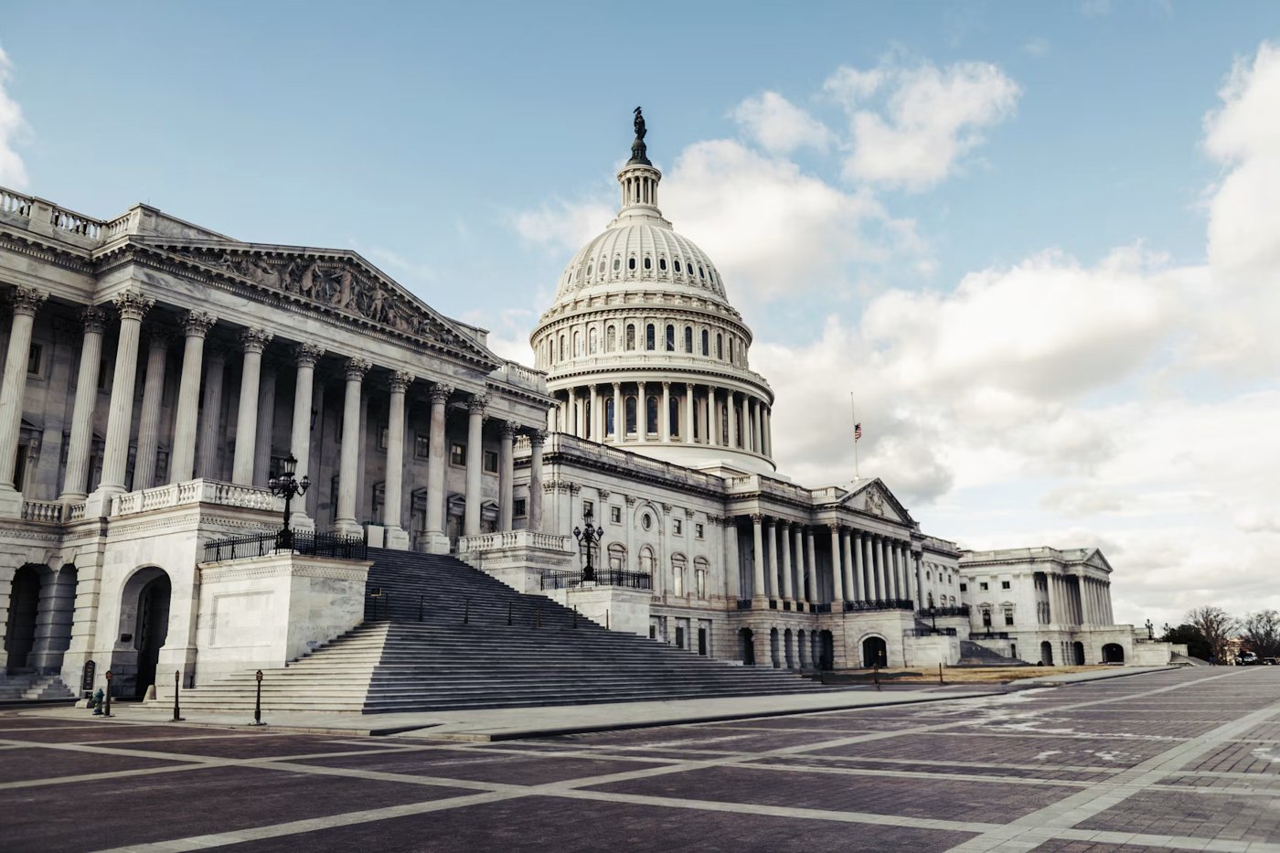 United States Capitol building with its dome and columns beneath a blue sky