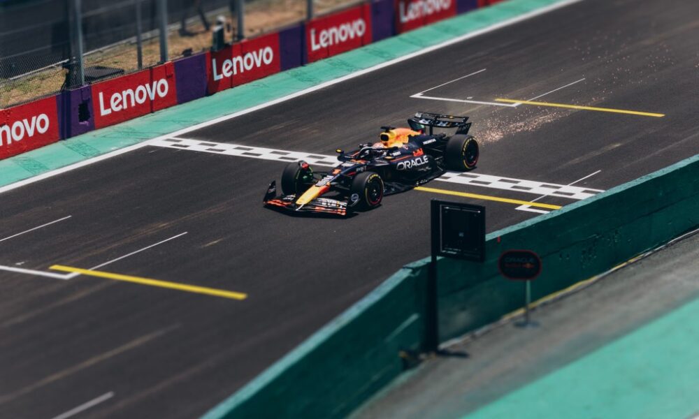 A Formula 1 car racing along a track with sparks behind it