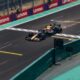 A Formula 1 car racing along a track with sparks behind it