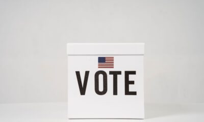 White ballot box marked Vote with an American flag design