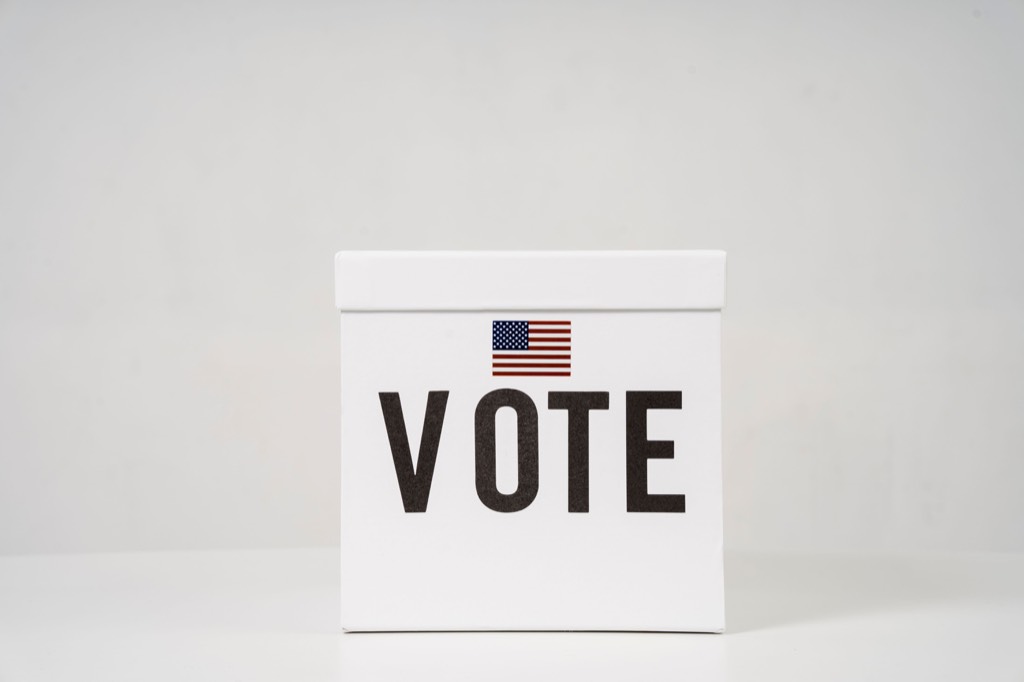 White ballot box marked Vote with an American flag design