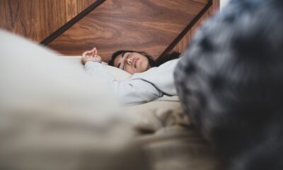 Woman resting on a white pillow in a bedroom
