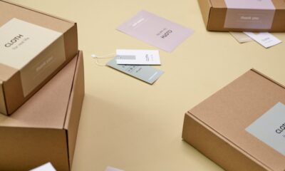 Plain cardboard boxes with white labels on a yellow surface