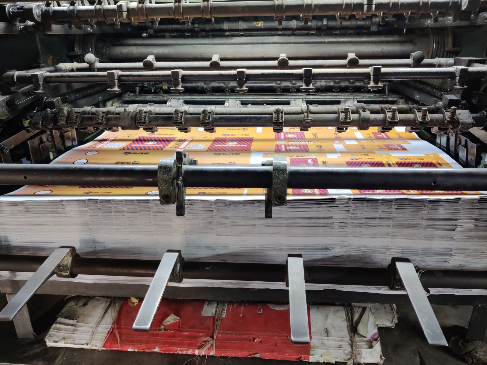 An industrial printing machine processing sheets of paper