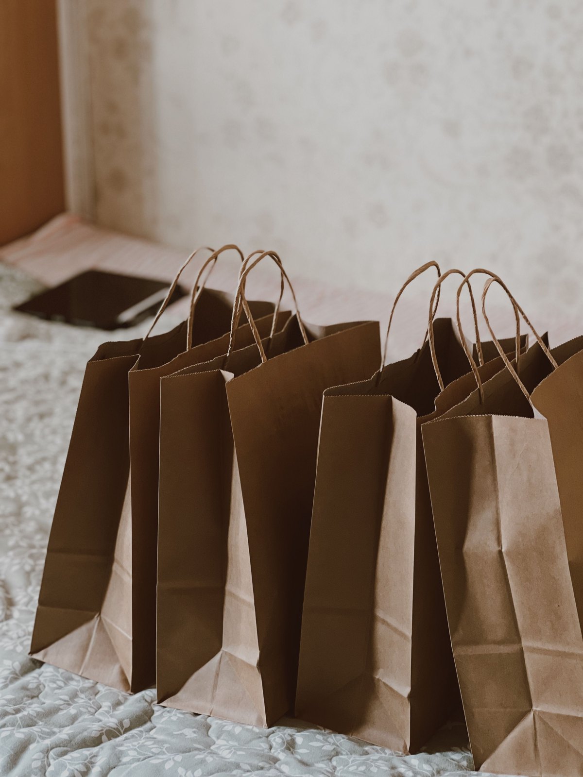 Plain brown paper shopping bags arranged indoors