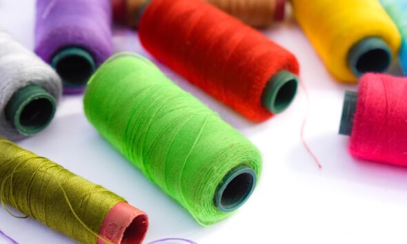 Spools of green, red, purple, yellow and pink sewing thread
