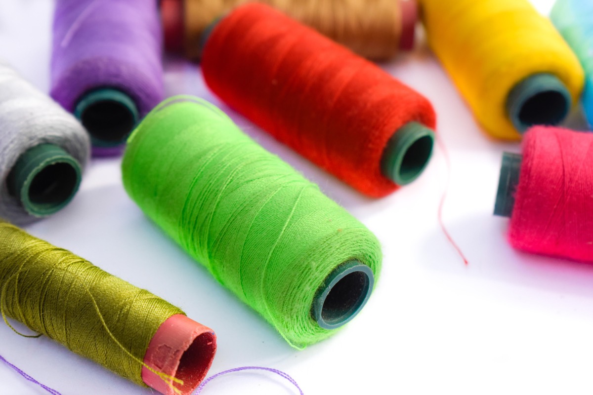 Spools of green, red, purple, yellow and pink sewing thread