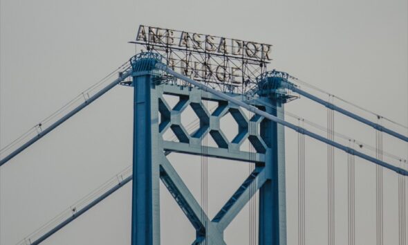 Blue steel structure of the Ambassador Bridge viewed from below